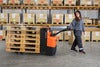 BT Pergo low-lifting powered pallet truck, application photo in warehouse.