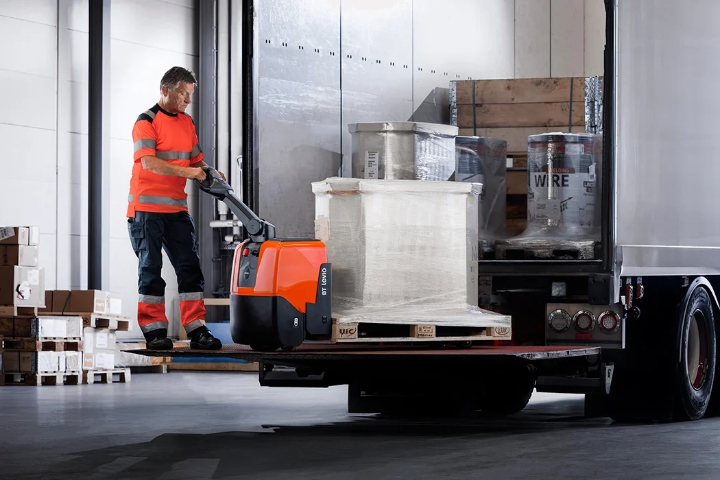 BT Levio LWE130 powered pallet truck, electric walkie low-lifter. Application photo showing loading and unloading from a lorry. 