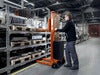 Toyota Lifter SHL080 hand pallet truck, electric stacker with forks raised. Application photo in a manufacturing environment. 