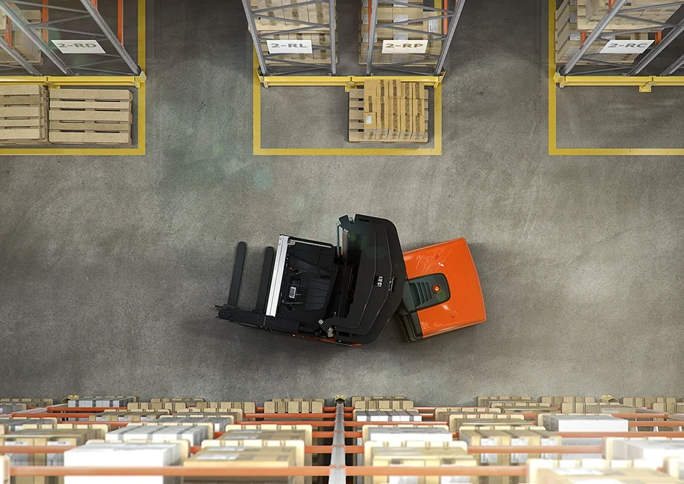 BT Vector VCE150A, man up, very narrow aisle truck. Application photo from above in warehouse environment.