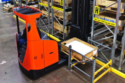 Product photo of reach truck with shuttle forks in use in warehouse.