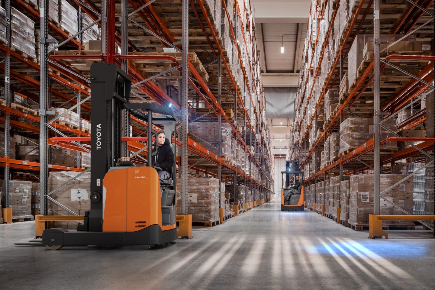 Application photograph in warehouse with two reach trucks.