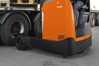 Product photo of reach truck driving outside on asfalt.