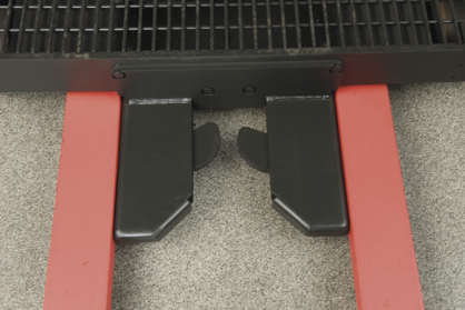 Close-up of forklift auto-locking pallet clamps without pallet.